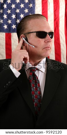 stock-photo-a-secret-service-agent-speaks-on-his-ear-piece-9592120.jpg