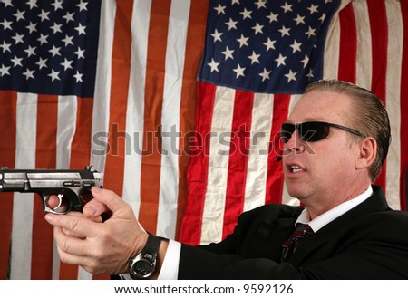 a Secret Service Agent points his weapon at a suspect
