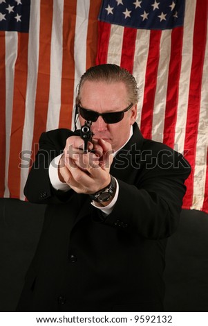 a Secret Service Agent points his weapon at YOU the Viewer
