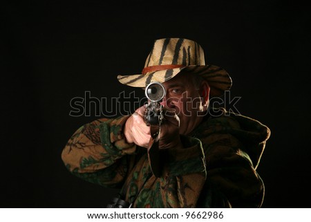 a hunter looks through his Rifle Sight  at YOU THE VIEWER against a black background showing an enlargement of his eyeball