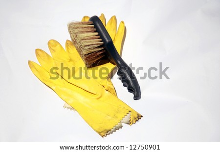 yellow rubber gloves and scrub brush on white, representing the cleaning service industry and other concepts