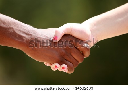 a black male and white female shake hands