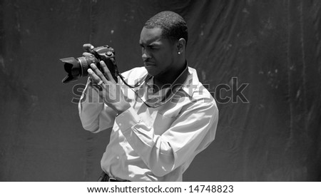a photographer reviews what he just captured on his Digital Camera Review Screen in black and white