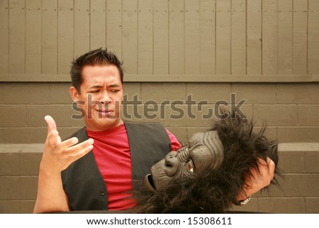 a male model makes a face at the request of the photographer to wear his Gorilla Costume Head