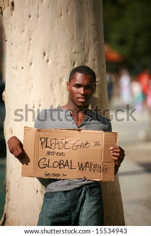 a man asks for donations to help stop Global Warming with his cardboard sign
