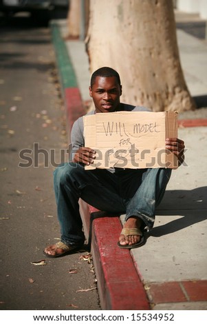 a male model holds a cardboard sign that reads \