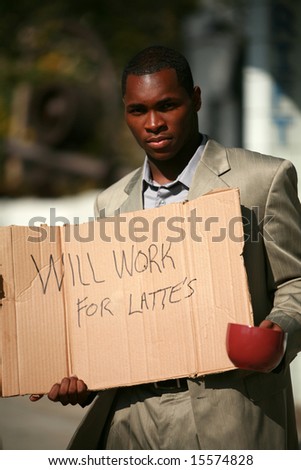 a thursty african american business man stands on a city street with a cardboard sign that reads \