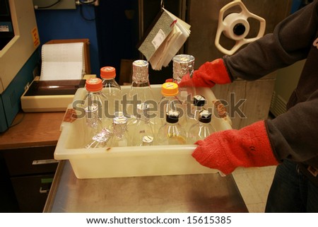 a person takes glass wear out of an autoclave in a science lab
