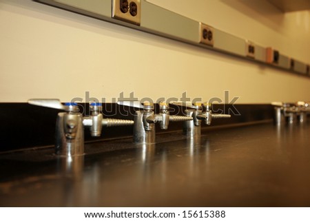 gas spigots on a work bench in a science lab