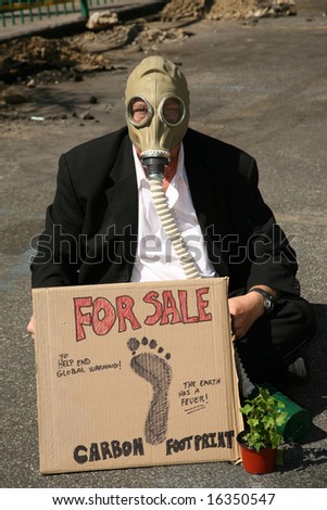 Global Warming concepts. a Business Man wears a Gas Mask and offers to sell his Carbon Footprint to help end Global Warming