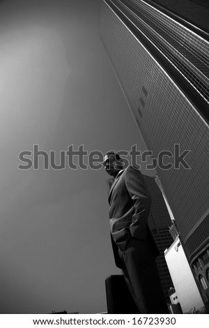 an african american business man outside of his office building   in black and white