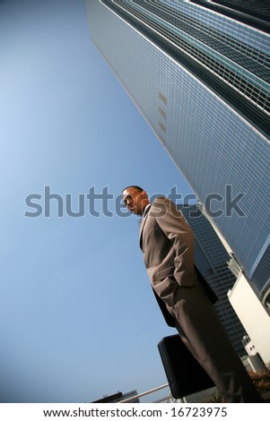 an african american business man outside of his office building