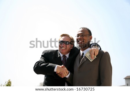 a corrupt politician takes a bribe from a scheming business man while posing for a photo op