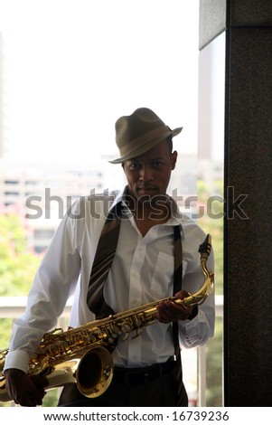 a cool cat takes a quick break from playing his sax in these moody images