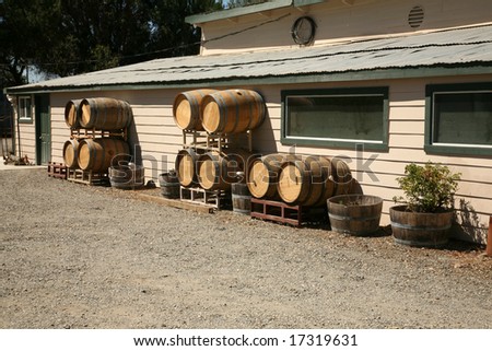 New Empty Wine Barrels lay against a building in Sonoma County California  aka \