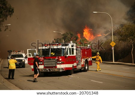 BREA, CA - NOV 15: Fire Fighters and emergency personal rush to control fires in Brea CA.  Many homes in the area have been destroyed as a result of the wildfires.