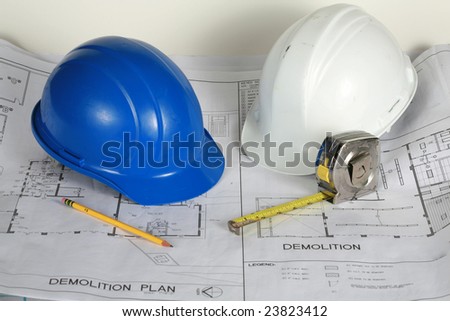 blue and white hard hats on blue prints