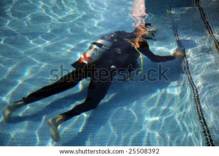 a scuba diver works on a swimming pool or practices his diving techniques you decide