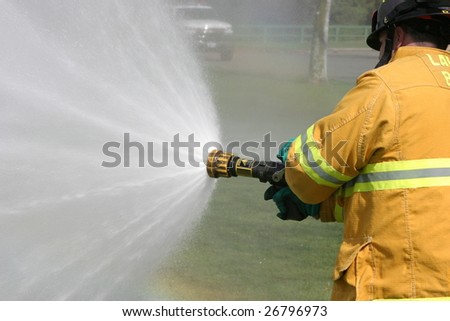 LAGUNA BEACH, CA - FEB 19: Firefighter recruit sprays water during fire fighting drills at the local Fire Department training area on February 19, 2009 in Laguna Beach, California.