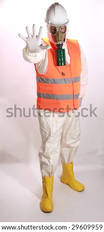 a man in a white hazmat suit, orange safety vest, and hard hat, and a gasmask holds his hand out to stop traffic representing the current Mexican Swine Flu Pandemic