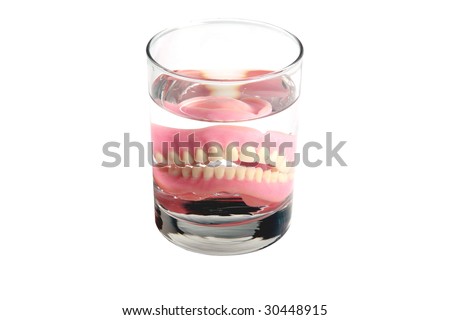 False Teeth in a glass of water \