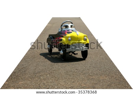 childs generic pedal car on a city street, cropped with the road as the vanishing point on white