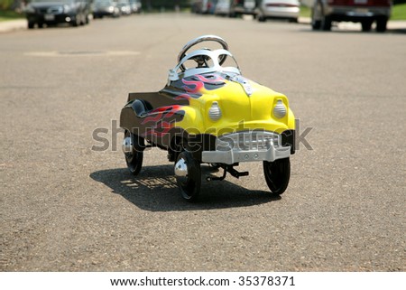 childs generic pedal car on a city street