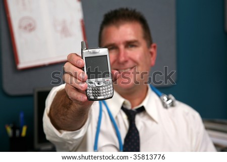 a doctor holds a cell phone represnting technology in the medical fields