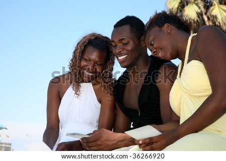 three friends enjoy looking at old photographs