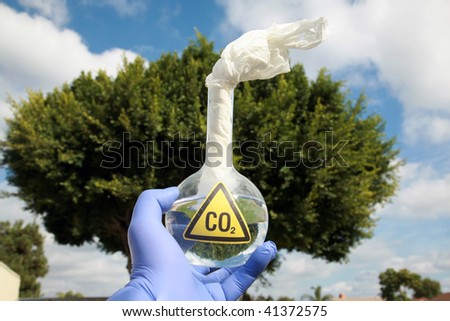 a Mad Scientist holds a 500ml beaker filled with CO2 with a paper wick as a Molotov cocktail against the blue sky, representing  A Global Warming Time Bomb
