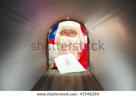 Santa Claus gets his mail from his mail box in the north pole before christmas eve