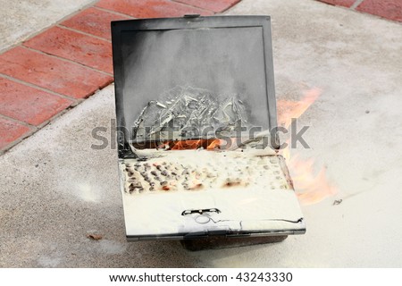 Laptop computer burned in a fire, represents computer damage, loss of data, emergency and more