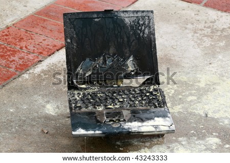 Laptop computer burned in a fire, represents computer damage, loss of data, emergency and more