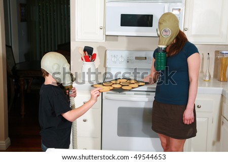 mother and son enjoy hot fresh baked cookies in their kitchen while wearing gas masks in the Future when Global Warming and CO2 have destroyed our way of living