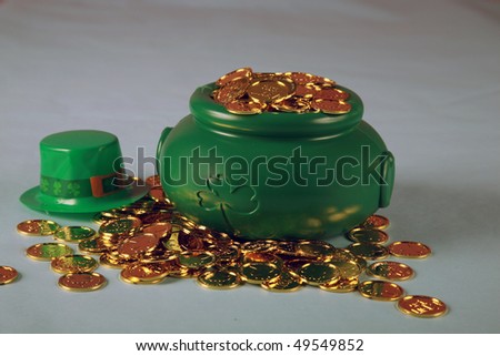 a Leprechaun\'s pot of gold coins on a blue and pink background