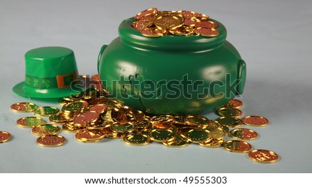 a Leprechaun\'s pot of gold coins on a blue and pink background