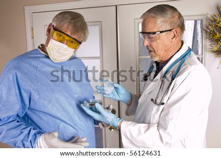 two doctors or surgeons or research scientist examine and discuss what they find in a growing in a petri dish
