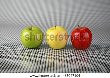 fresh picked apples of red green and gold on a black and white background