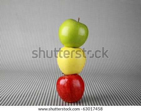beautiful fresh picked right off the tree green yellow and red apples on a black and white background, called a \