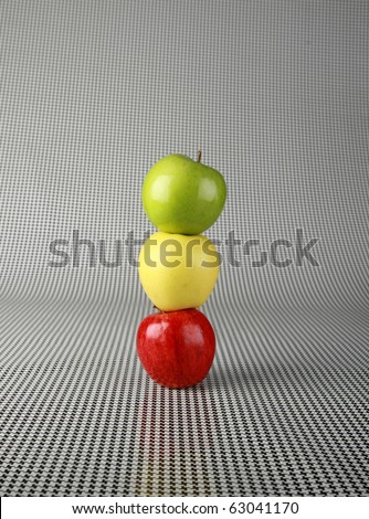 fresh picked apples of red green and gold on a black and white background