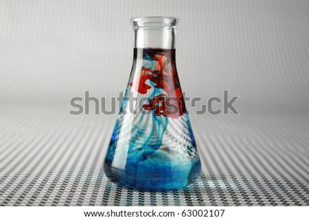a chemist or medical research scientist adds chemicals to a erlenmeyer flask for a violent chemical reaction on a black and white background