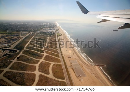Leaving Los Angeles airport in an airplane aka LAX and flying over the pacific ocean on the way to Maui Hawaii