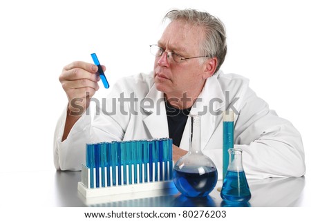 Scientific concept--Scientist holding a mixes chemicals in a beaker with liquid over a scientific background of the periodic tables of chemistry with room for your text.