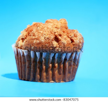 A healthy sugar free, gluten free apple muffin on a blue background