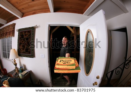 a pizza delivery man brings you Fresh Baked Pizza right to your door shot with a fisheye lens for a fun and funny image. isolated on white with room for your text. in a Generic pizza box