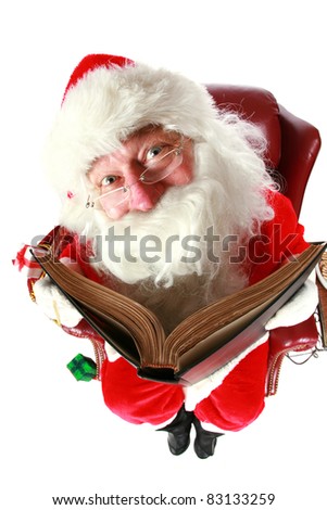 Santa Claus checks who has been naughty or nice in his big book. shot with a fisheye lens for a fun festive event. isolated on white with room for your text