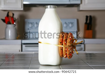 Cookies and Milk with an antique glass milk bottle on a kitchen counter for a after school snack of \