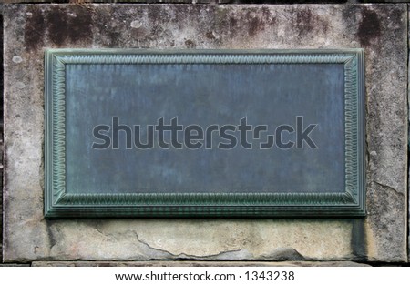 A weathered plaque embedded in a wall stone. Empty to fill in your info.