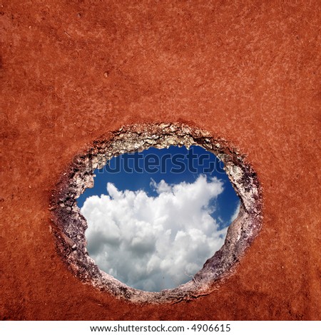 View of the sky as seen from under a hole in the ground.
