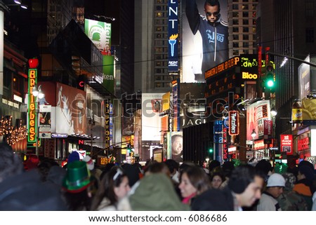 Street level view of New Years festivities at Times Square. [focus is on signs].